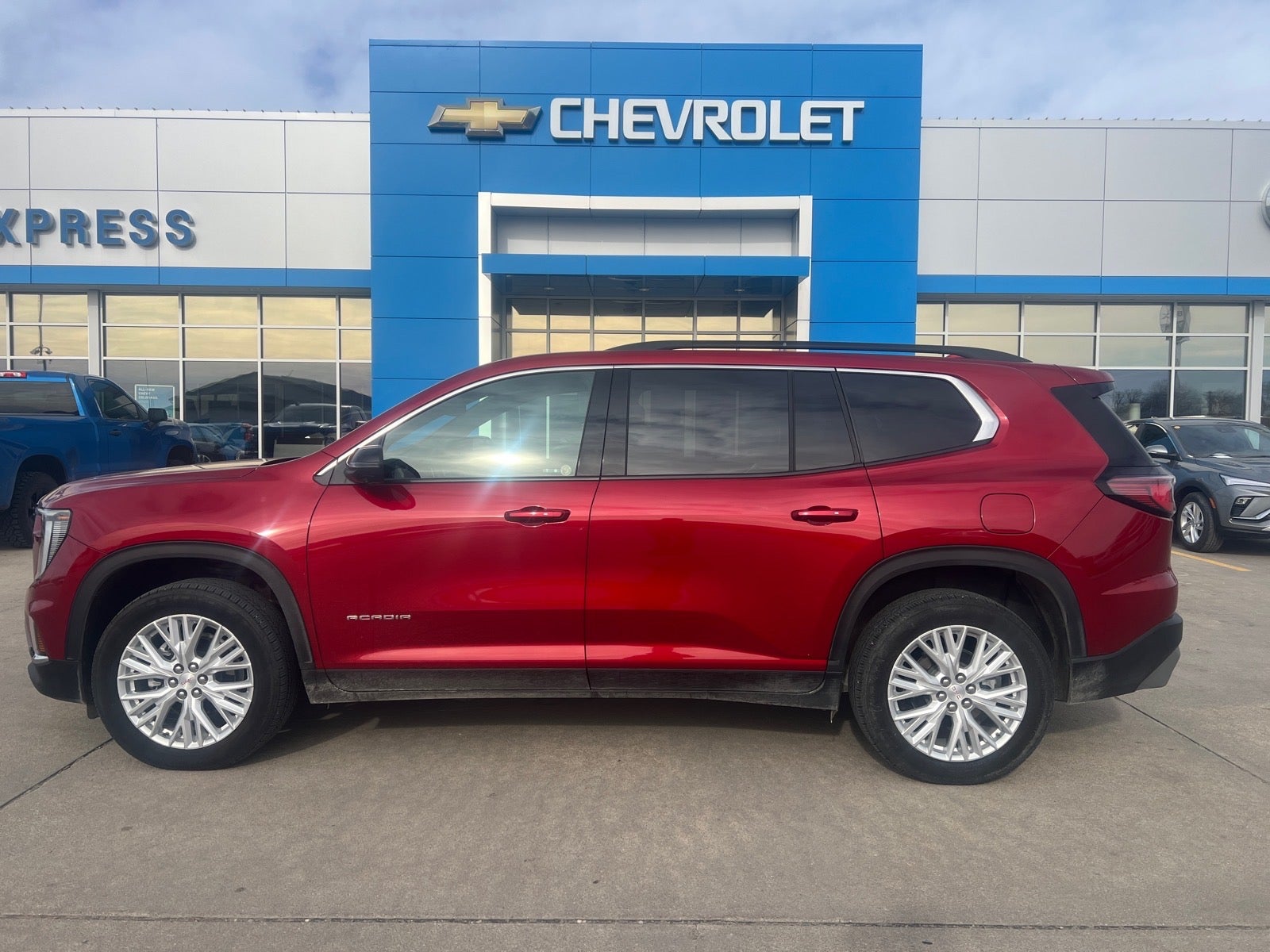 2025 GMC Acadia Elevation in Volcanic Red Tintcoat — front three-quarter view