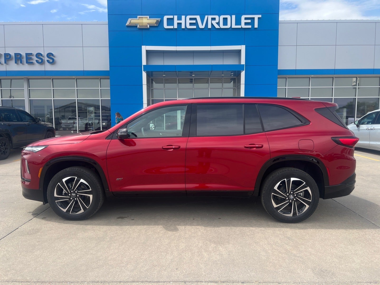 2026 Buick Enclave Sport Touring in Cherry Red Tintcoat — front three-quarter view