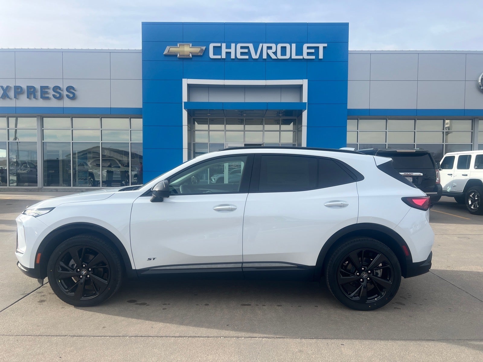 2026 Buick Envision Sport Touring in Iridescent White Tricoat — front three-quarter view